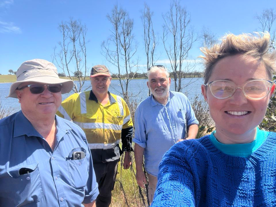 Bill Hollingworth, Farmer Anthony Hall, Green Skills Inc's Basil Schur and Rhian Thomas, with Lake Near behind - team planning wetland revegetation for 2025