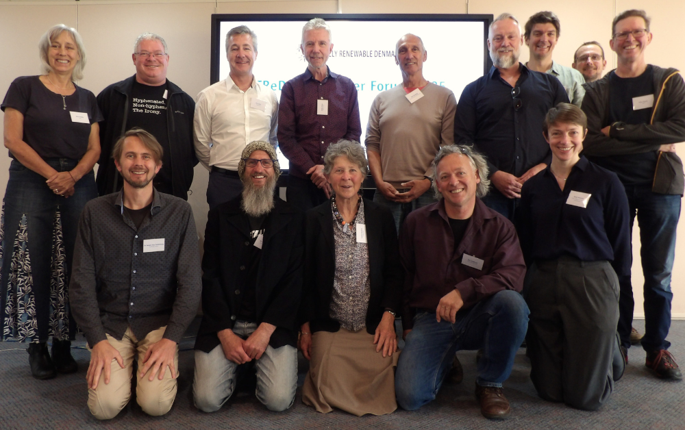 A group of forum attendees posing for a group photo.